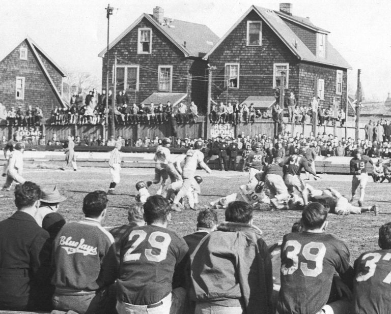 Spectators crowding the sideline at the Curtis-New Dorp game at Thompson's Stadium on Thanksgiving Day, 1948.
